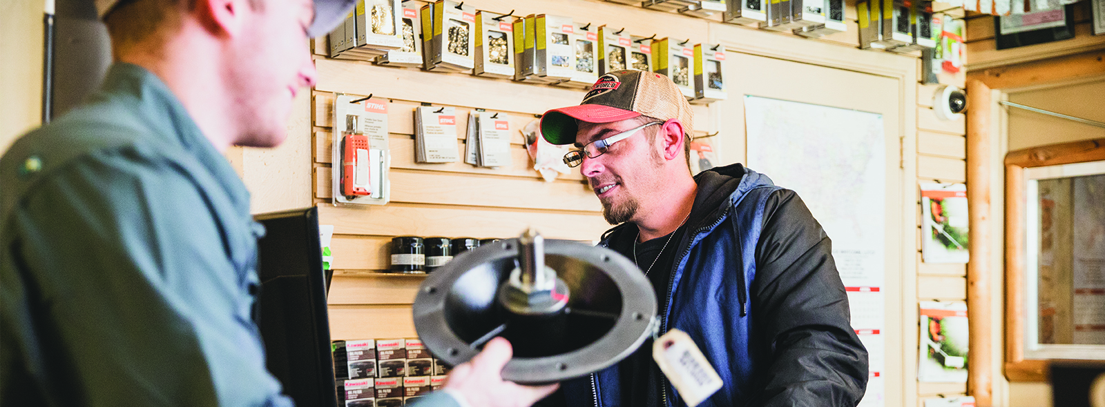 Dealer showing customer a part