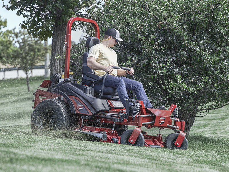 Man mowing law on Ferris ISX 3300 EFI-ETC zero turn mower