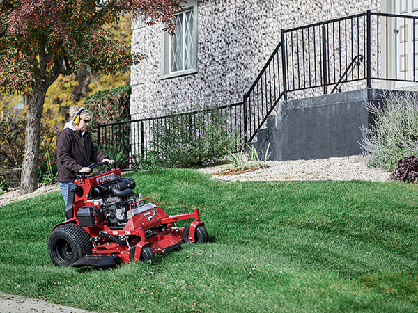 Woman standing on SRS Z3 mower cutting grass