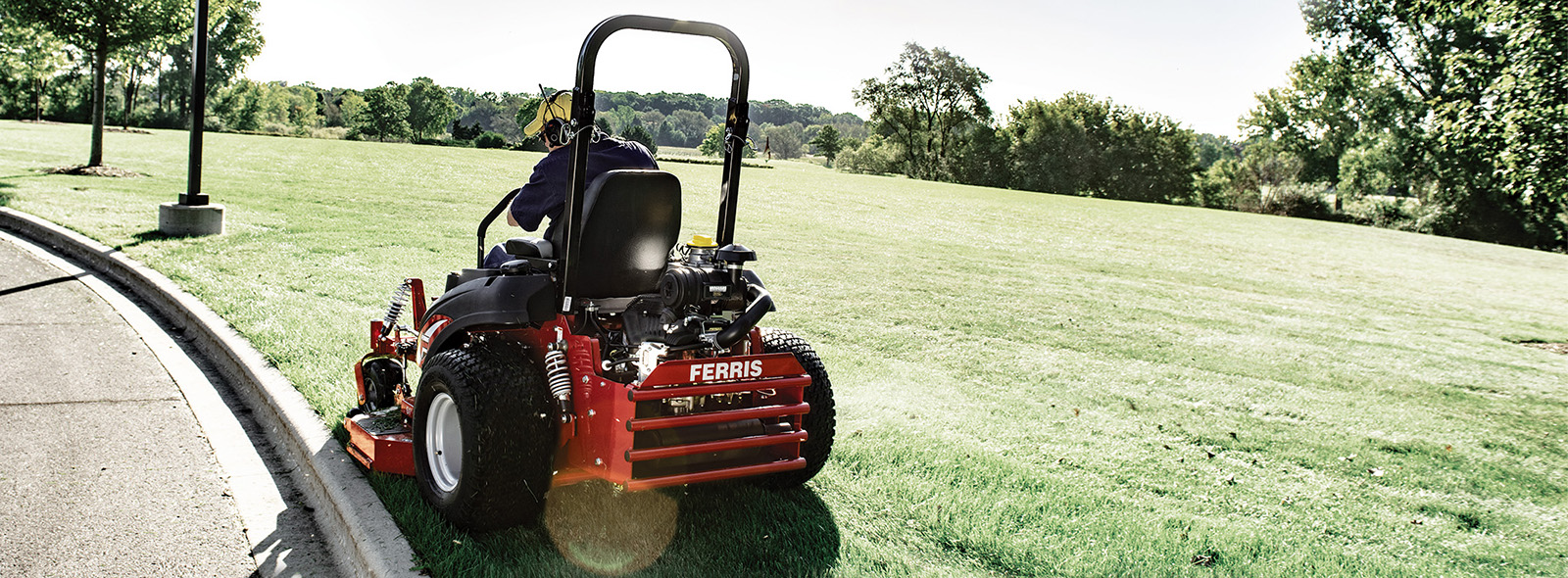 Man cutting grass on Ferris zero turn mower