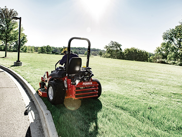 Man cutting grass on Ferris zero turn mower